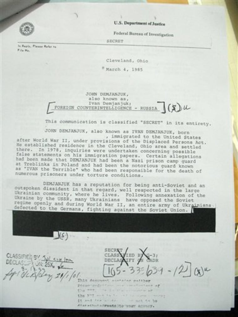 This Feb. 25, 2011 picture made at the U.S. National Archives in College Park, Md. shows a newly-declassified, partially-redacted FBI report on John Demjanjuk. In this 1985 report, the Cleveland FBI field office expressed serious doubts about evidence key to the current prosecution of John Demjanjuk on Nazi war crimes allegations, according to documents uncovered by The Associated Press, telling headquarters that Soviet intelligence might be duping the U.S. Department of Justice. (AP Photo)